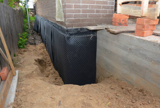SJ Waterproofing Pros technician performing targeted Basement Waterproofing assessment in Schoolcraft, MI
